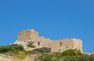 Historic Kritinia Castle on top of hill in Rhodes island, Greece. Idyllic countryside nature, blue sky. Castle of Kritinia also known as Kastello.