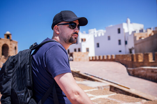 Happy tourist man visiting Essaouira, Marrakech, Morocco. Taking mobile phote picture