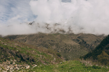 The Caucasus Mountains. The snow-covered peaks are shrouded in thick white clouds.