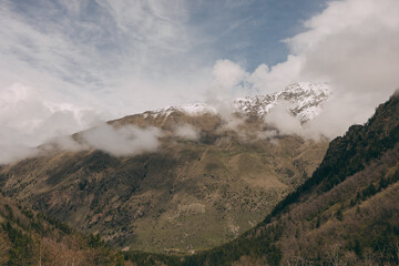 The Caucasus Mountains. The snow-covered peaks are shrouded in thick white clouds.
