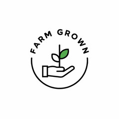 A hand holding a small plant with farm grown text in a circular frame