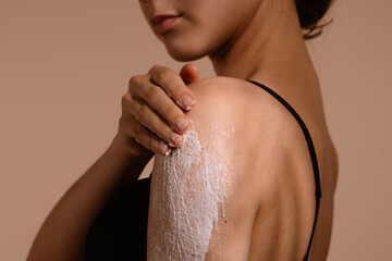 Woman Applying Scrab to Her Shoulder Gently