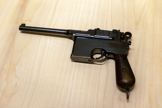 Mauser pistol top view on a wooden table. mock-up of an old pistol.