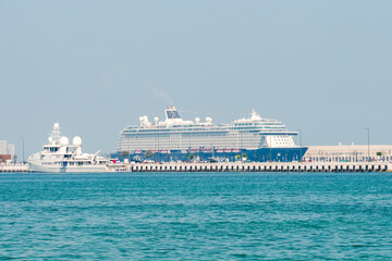 A modern cruise ship berthed at the cruise terminal in port.