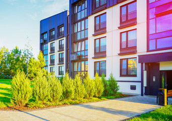 Modern Front Yard. Lawn at entrance of residential building block. Landscaping for urban spaces. New apartment building block in green enviroment. Condominium complex with green courtyard on street.