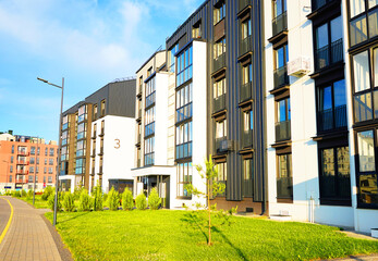 Modern Front Yard. Lawn at entrance of residential building block. Landscaping for urban spaces. New apartment building block in green enviroment. Condominium complex with green courtyard on street.