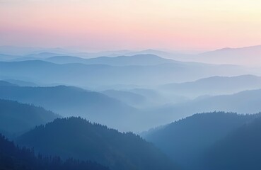 Obraz premium Panoramic photo of misty mountain range at dawn. Blue haze covers landscape. Photo shows mountain silhouette, peaceful tranquil scene in morning twilight, ideal for travel, vacation projects.