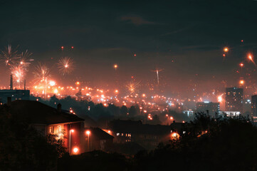 Enchanting night sky filled with fireworks over urban landscape during New Years Eve celebration