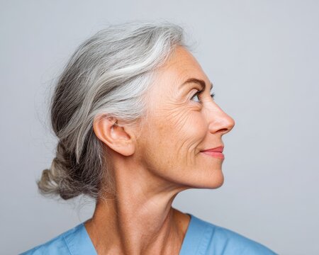 Nurse Profile. Senior Hispanic Woman Doctor in Portrait Pose with Confident Smile on Isolated Background