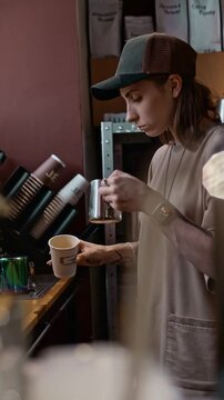 cute hipster girl making coffee professionally