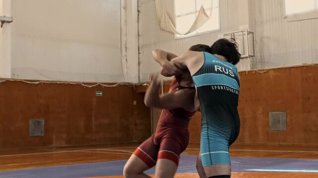 teenage sambo wrestlers in clinch during training