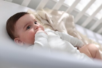 Bedtime. Cute little baby in crib at home