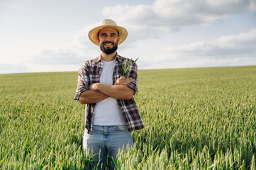 Positive facial expression, smiling. Man farmer is on the agricultural field