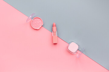 Makeup accessories - brushes and pink pastel cosmetic products, flat lay, top view