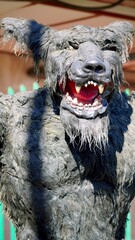 Close up of a scary werewolf monster roaring showing its teeth and red tongue, creating a spooky...
