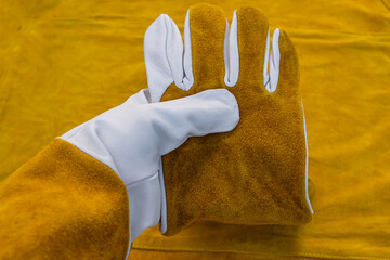 Welder's Protective Clothing is Made of Beef Split. Person Demonstrate Welding Gloves and an Apron....