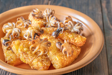 Golden Potato Rosti With Baby Octopuses Served On Rustic Wooden Table Plate
