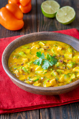 Rustic bowl of mango salsa bursting with color and fresh tropical flavor