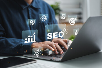 Naklejka premium Businessman using computer to analyze SEO, search engine optimization, marketing, traffic ranking, website, internet, business, technology, concept.