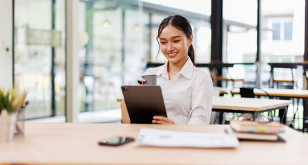 Young asian business woman manager accounting analyst checking bills, analyzing sales statistics...