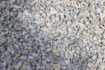Close-up of gray crushed gravel stones for construction and landscaping