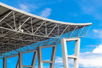 Futuristic metal structure against blue sky with geometric design