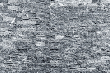 Gray brick wall pattern with textured stone surface in urban setting