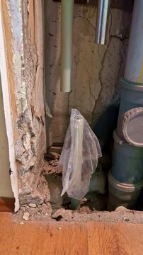 Exposed plumbing risers and wall damage during residential renovation process