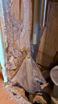 Plastic-covered riser in wall cavity during renovation of old residential apartment, vertical