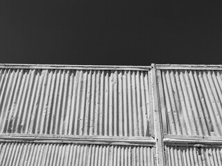 Metal Door Frame Fence with Sky Background – Low Angle Perspective. Monochrome Hues.
