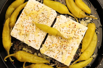 Baked feta cheese with pepperoni and onions	