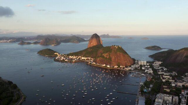 Aerial view of Guanabara Bay with natural landmark Sugarloaf Mountain at sunset in Rio de Janeiro, Brazil.