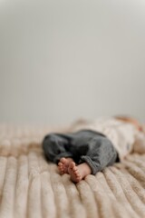 Blurred Baby on Beige Bedspread