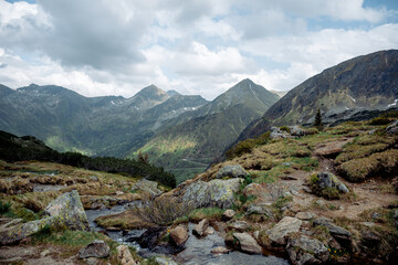 Mountain landscape with rocky trail and alpine stream in the Austrian Alps