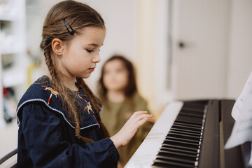 Young Girl Playing Piano with Focus