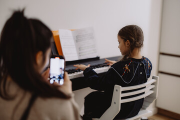 Young Girl Playing Piano While Being Photographed