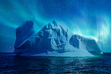 Iceberg floating in the sea near greenland fjord with aurora borealis - Greenland