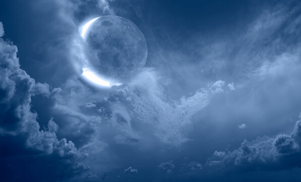 Night sky with full bright crescent moon in the clouds "Elements of this image furnished by NASA"