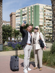 Business professionals taking a selfie outdoors