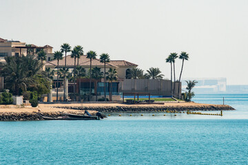 beautiful luxury house with European architecture on seashore with a beach and turquoise water. luxury real estate. expensive real estate by the sea.