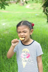 Fototapeta premium Portrait of asian cute little girl eating food