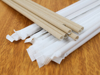 Brown paper drinking straw isolated on wooden background