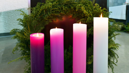 Advent candles and evergreen wreath in Catholic church for Christmas Mass