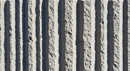 Rugged Rough Chiseled Granite Wall with Distinct Vertical Tool Marks Texture