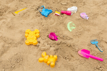Abandoned old toys on a playground with sand. Top view