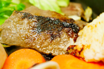Beef, vegetables, rice balls, and yakiniku grilled on a hot plate