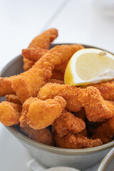 Enjoy Crispy Fried Seafood served with a fresh Lemon Wedge that enhances its flavor
