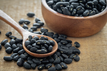 Black bean on wooden spoon