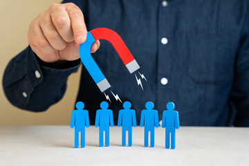 A man with a magnet attracts people. Leadership charisma. Attracting clients or hiring. Recruitment...