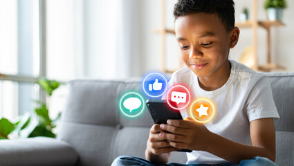 Afro-American Boy using social media, holding smart phone with icons of like, comment, star over it. schoolboy playing on smart phone. children's cybersecurity, social media addiction, communication